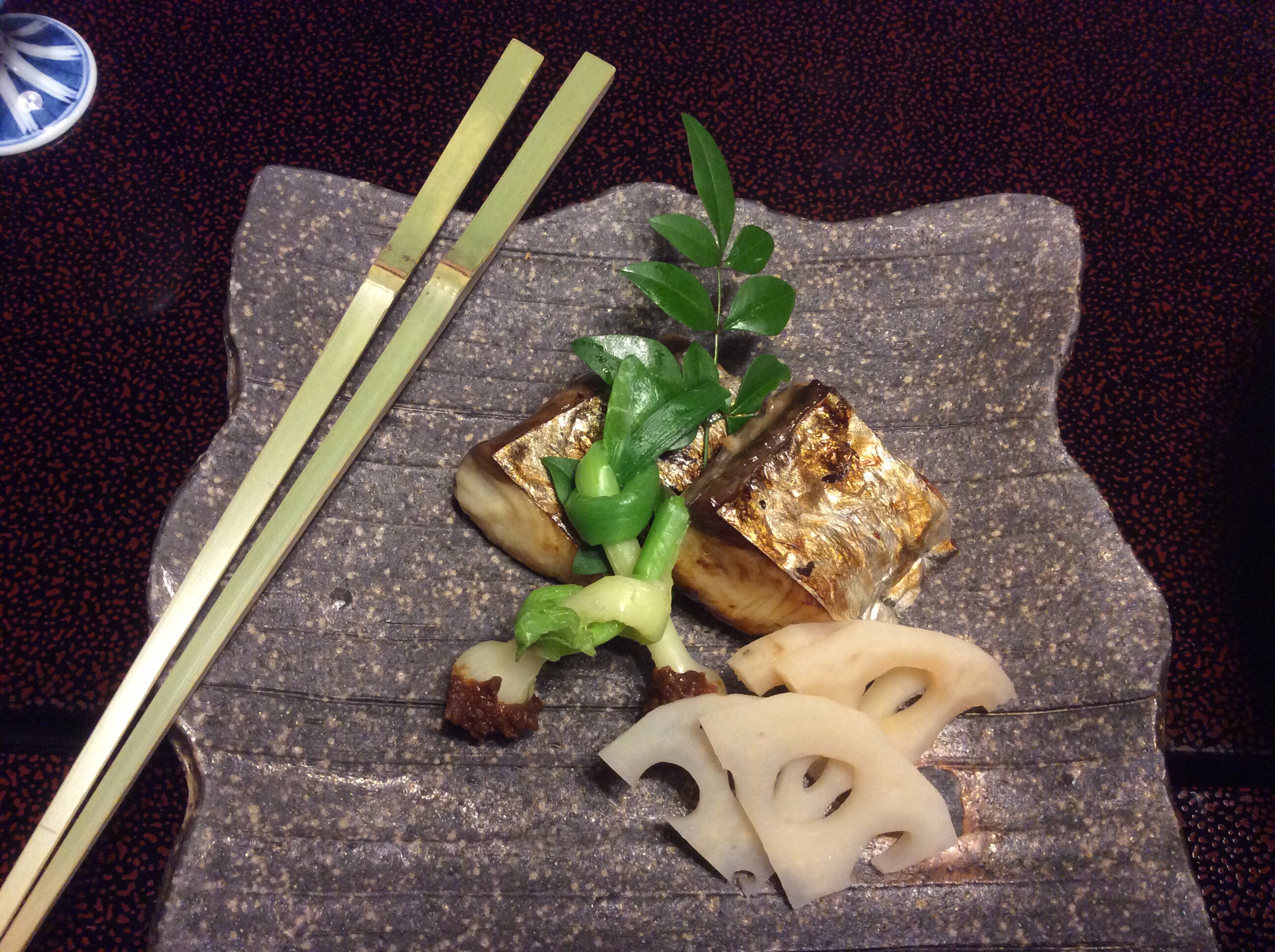 The fish is Spanish Mackerel. The vegetable accompaniments are baby onions and lotus root.